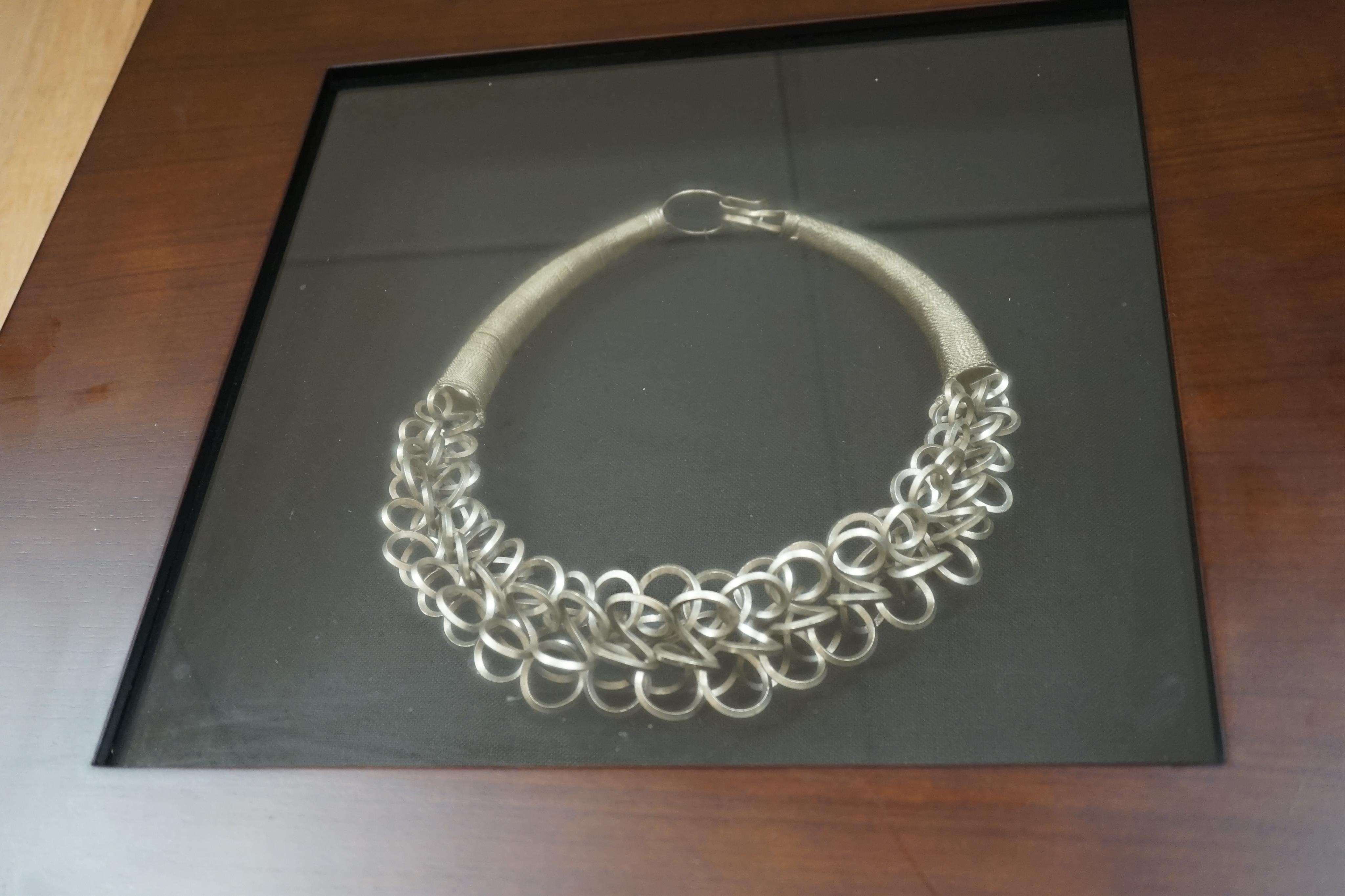 Two Chinese Miao framed white metal necklaces, frames 55cm sq. condition - fair to good